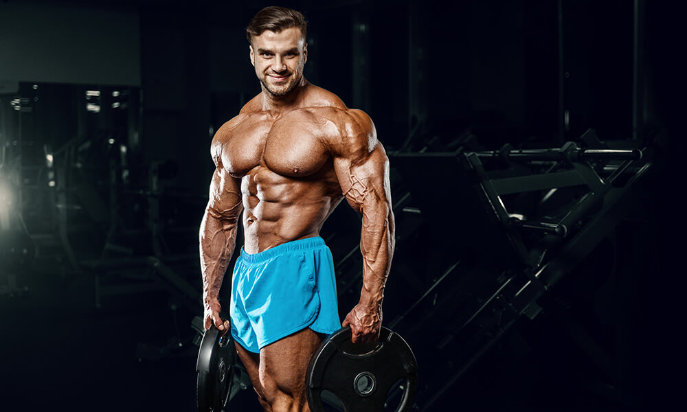 a bodybuilder holding two plates